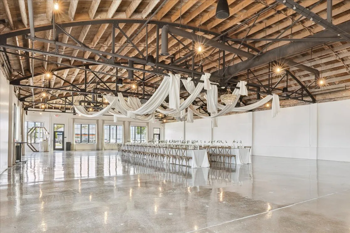 The same building after renovation, with polished concrete floors and an open wood ceiling